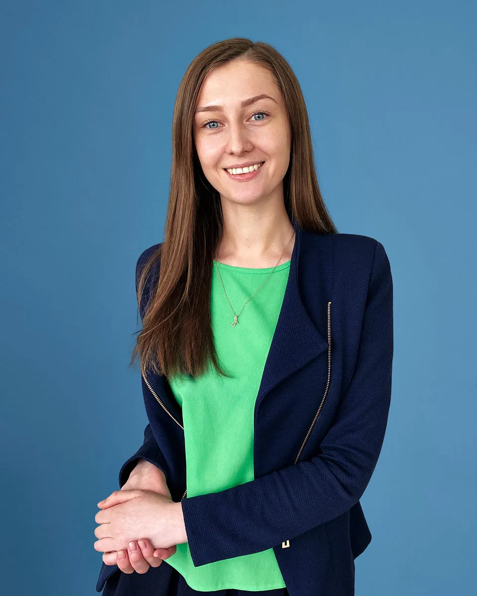 A real, photographer-captured remote headshot of a woman — not an AI-generated image.