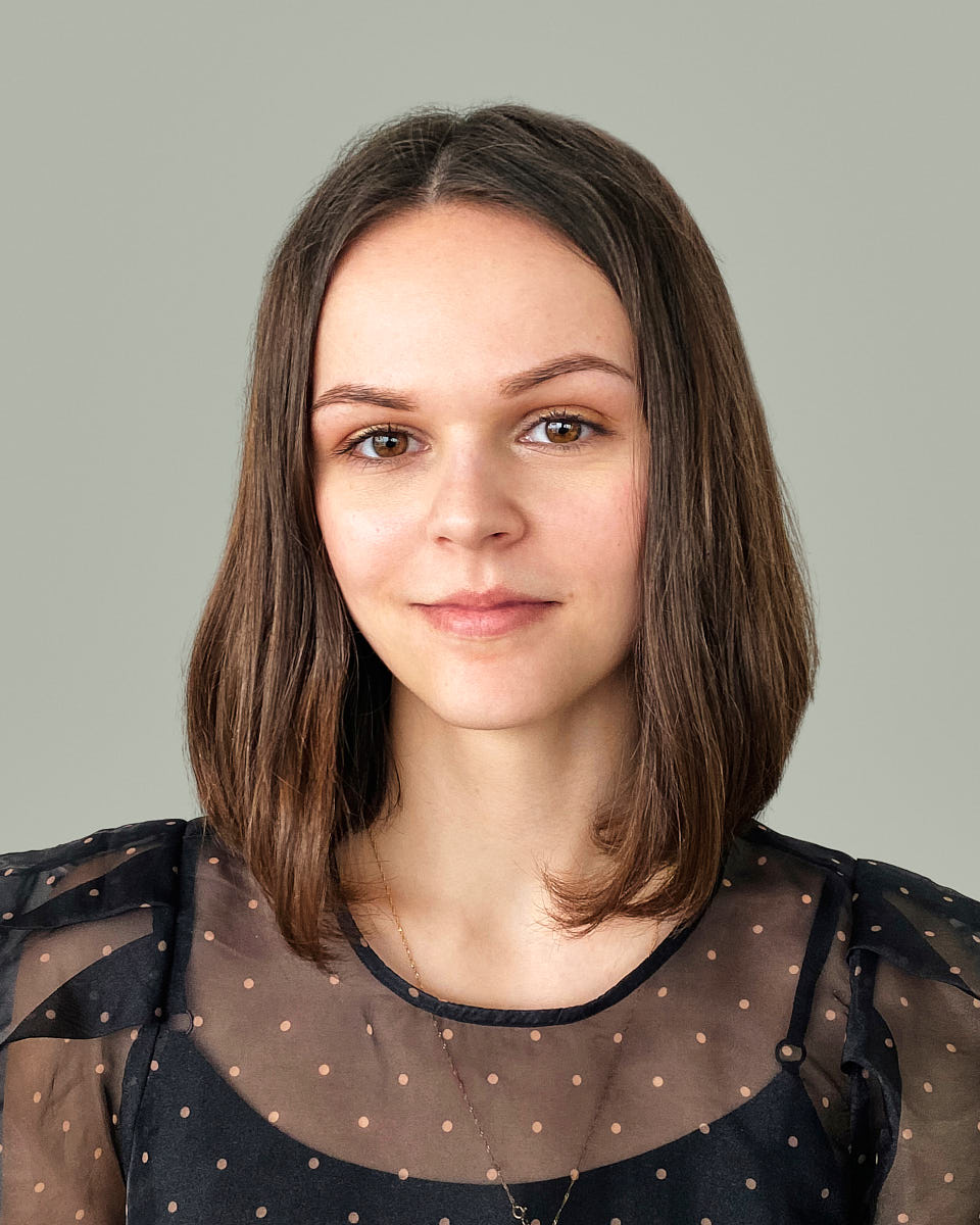 Consistent employee headshot of a woman photographed against a simple neutral backdrop.