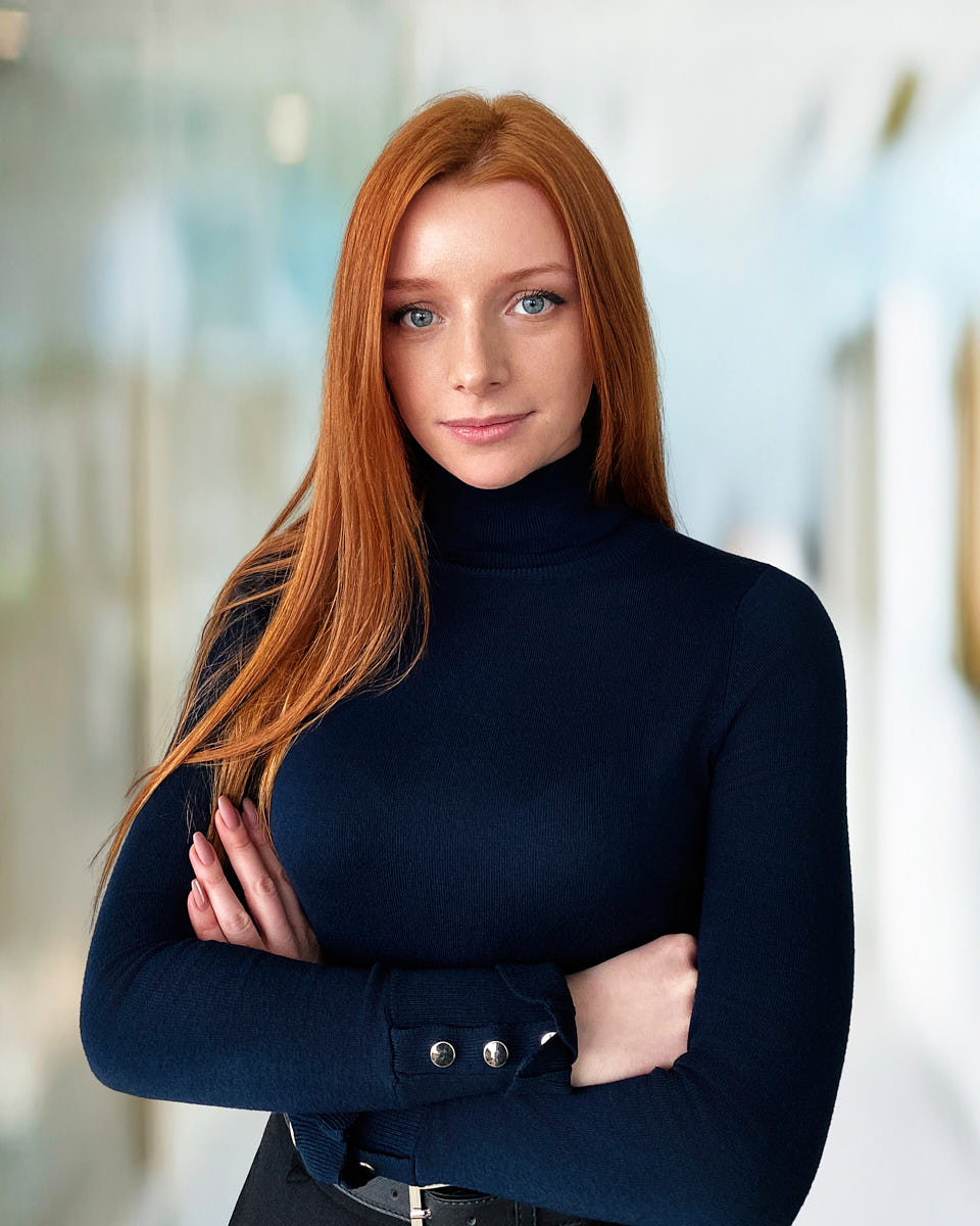 Remote professional headshot of a woman in a black turtleneck with a polished, natural look.